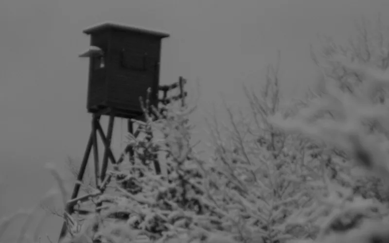 Why a RHINO Hanger is Your Secret Weapon for Organizing Your Hunting Gear | Heavy Duty Hangers by Tough Hook Elevated wooden hunting stand in snowy woods where gear is kept organized and quiet